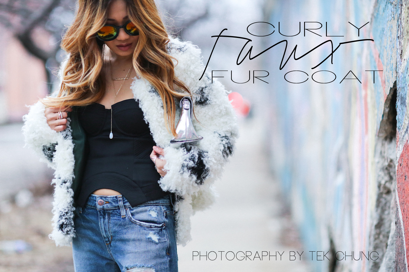 corset top and curly faux fur coat with reflective sunglasses and ripped jeans