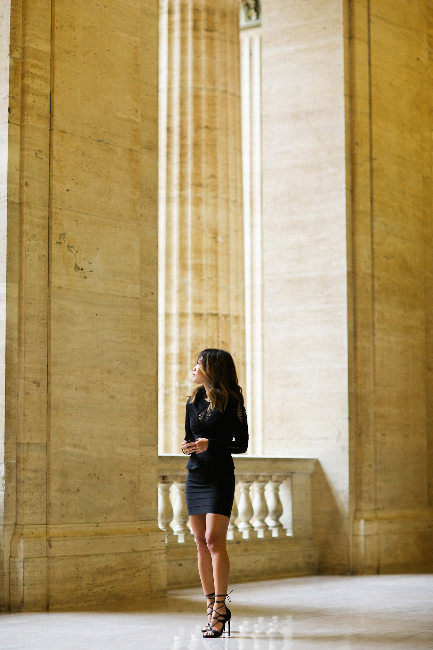 black herve leger peplum dress layered with crop top