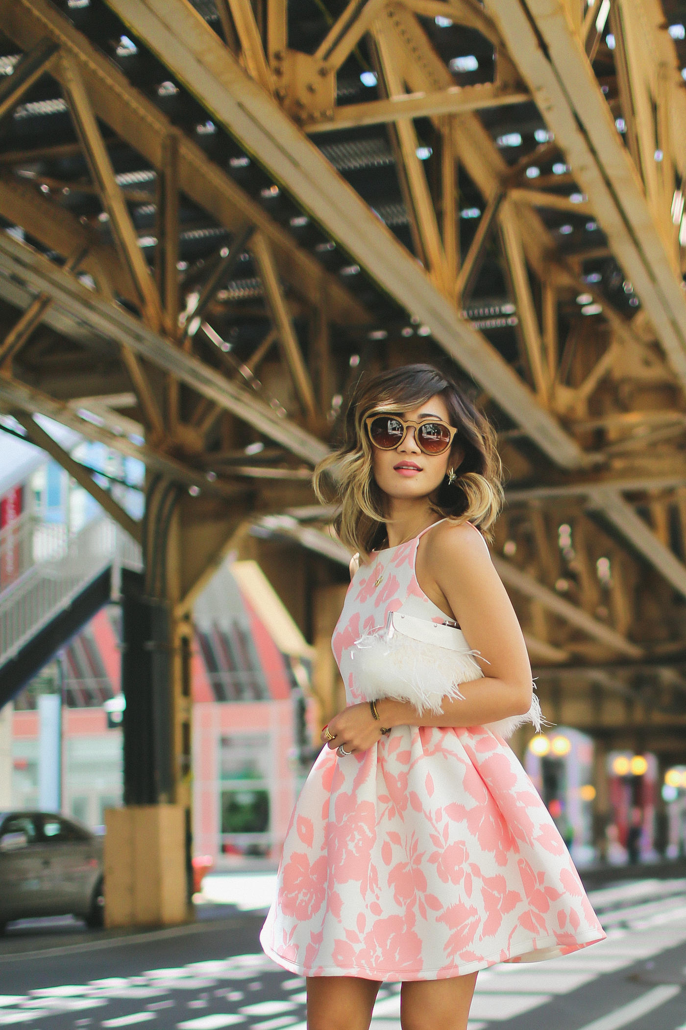 pink floral print flare dress from generation bliss and bcbg feather clutch