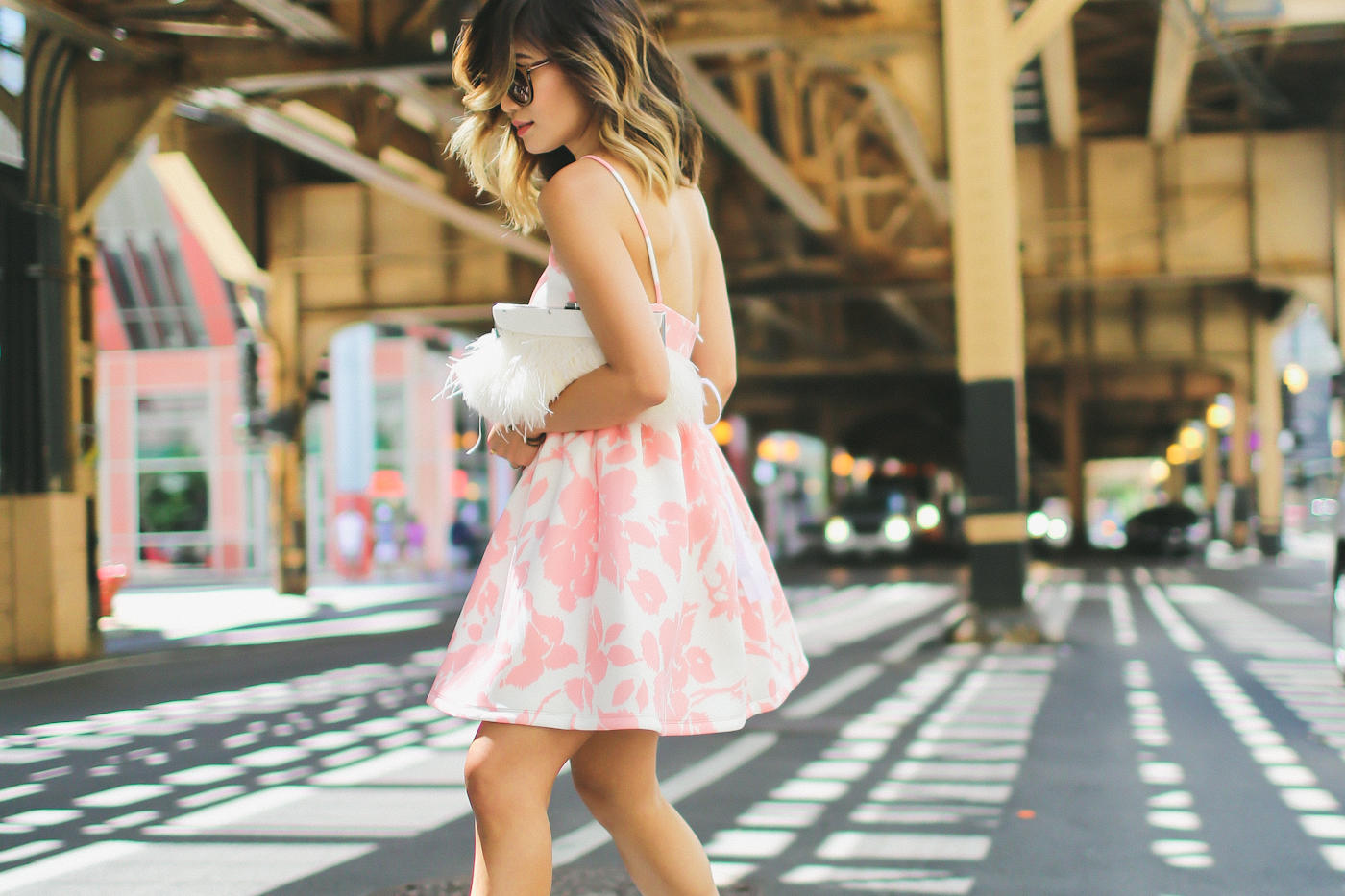 pink floral print flare dress from generation bliss and bcbg feather clutch