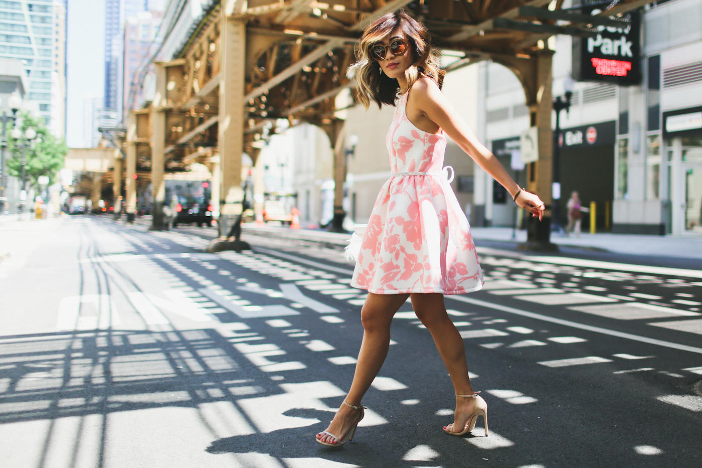 pink floral print flare dress from generation bliss and bcbg feather clutch