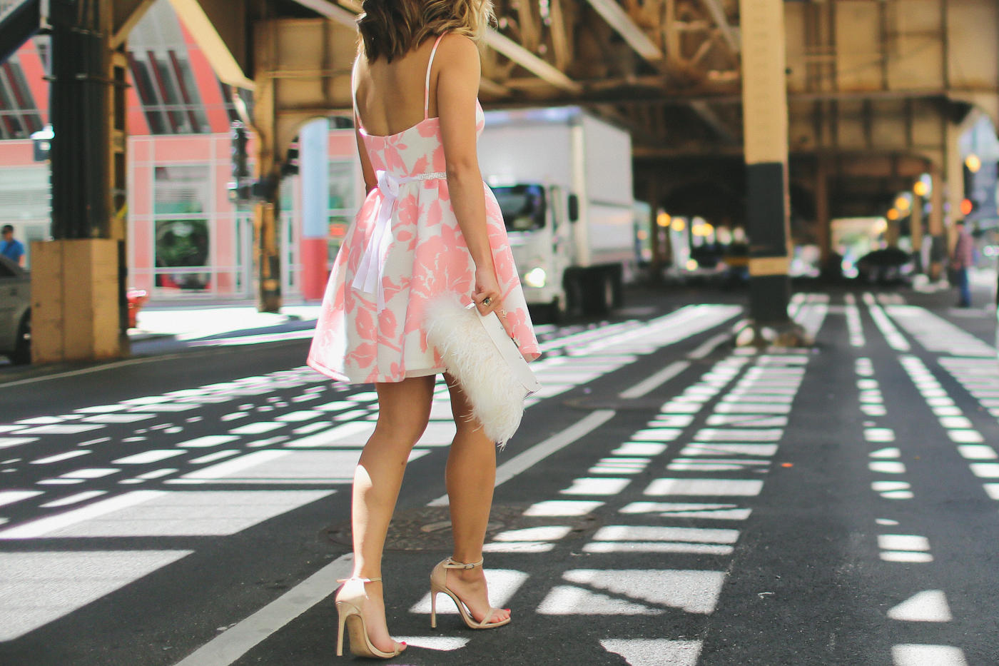 pink floral print flare dress from generation bliss and bcbg feather clutch