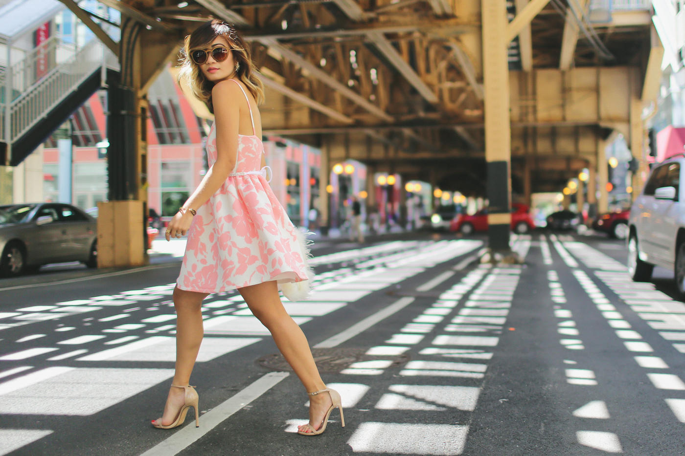 pink floral print flare dress from generation bliss and bcbg feather clutch