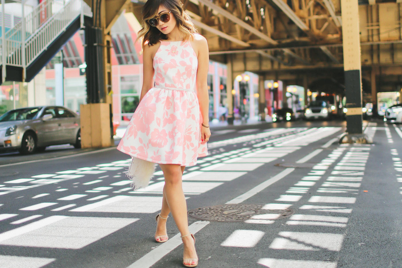 pink floral print flare dress from generation bliss and bcbg feather clutch