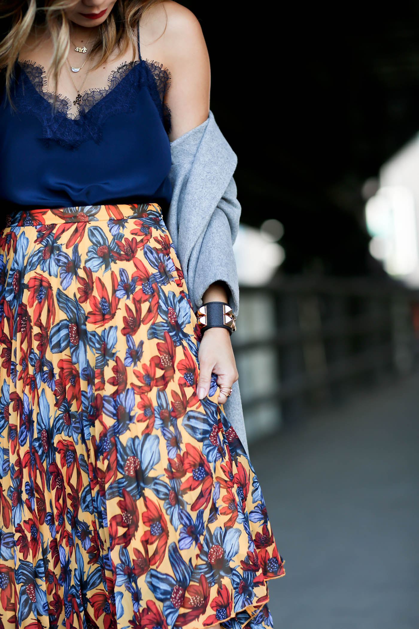 dressy lace cami with pleated skirt and oversized coat