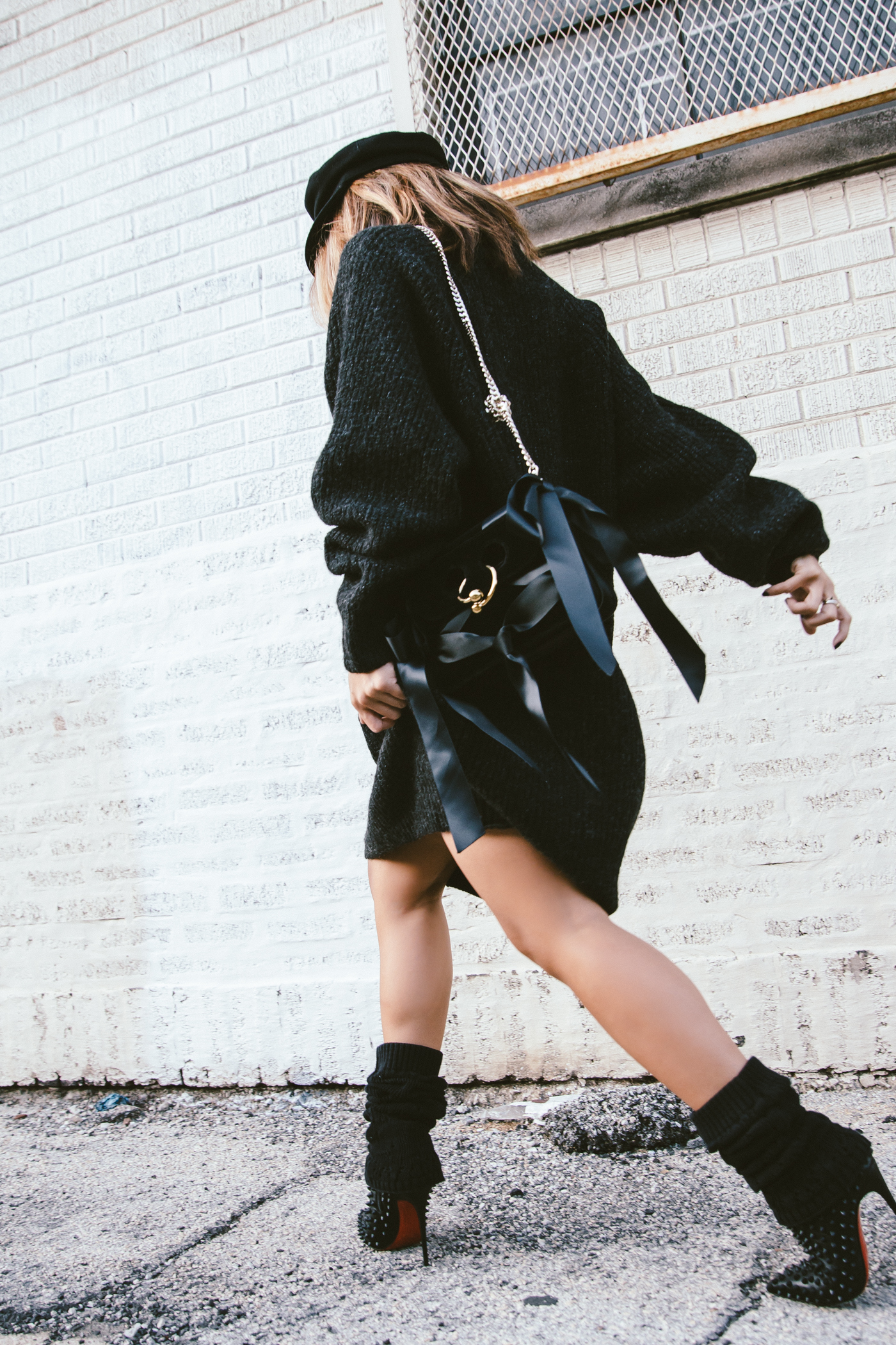 oversized sweater dress with christian louboutin ankle boots and leg warmers newsboy cap and jw anderson bow pierce bag