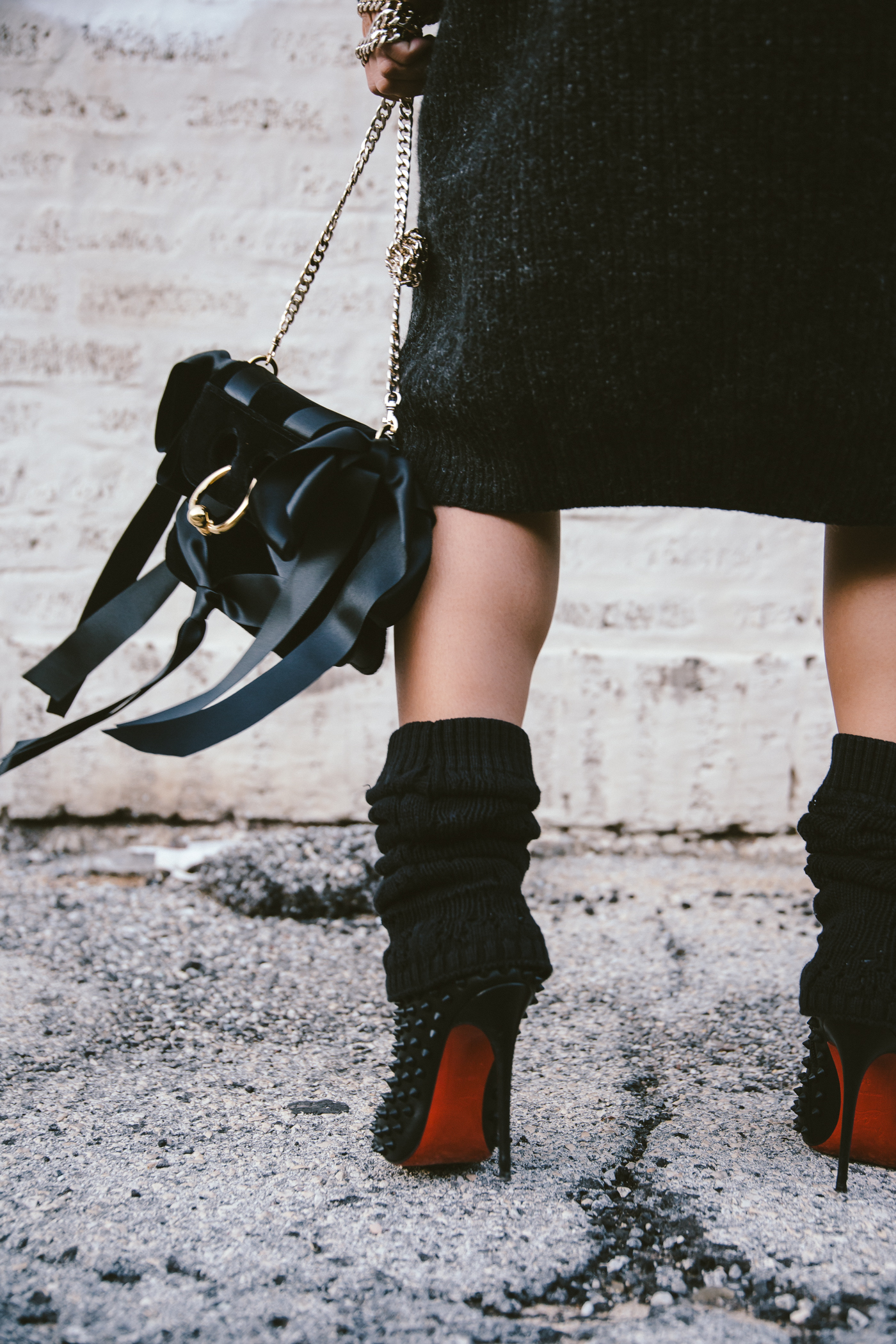 oversized sweater dress with christian louboutin ankle boots and leg warmers newsboy cap and jw anderson bow pierce bag