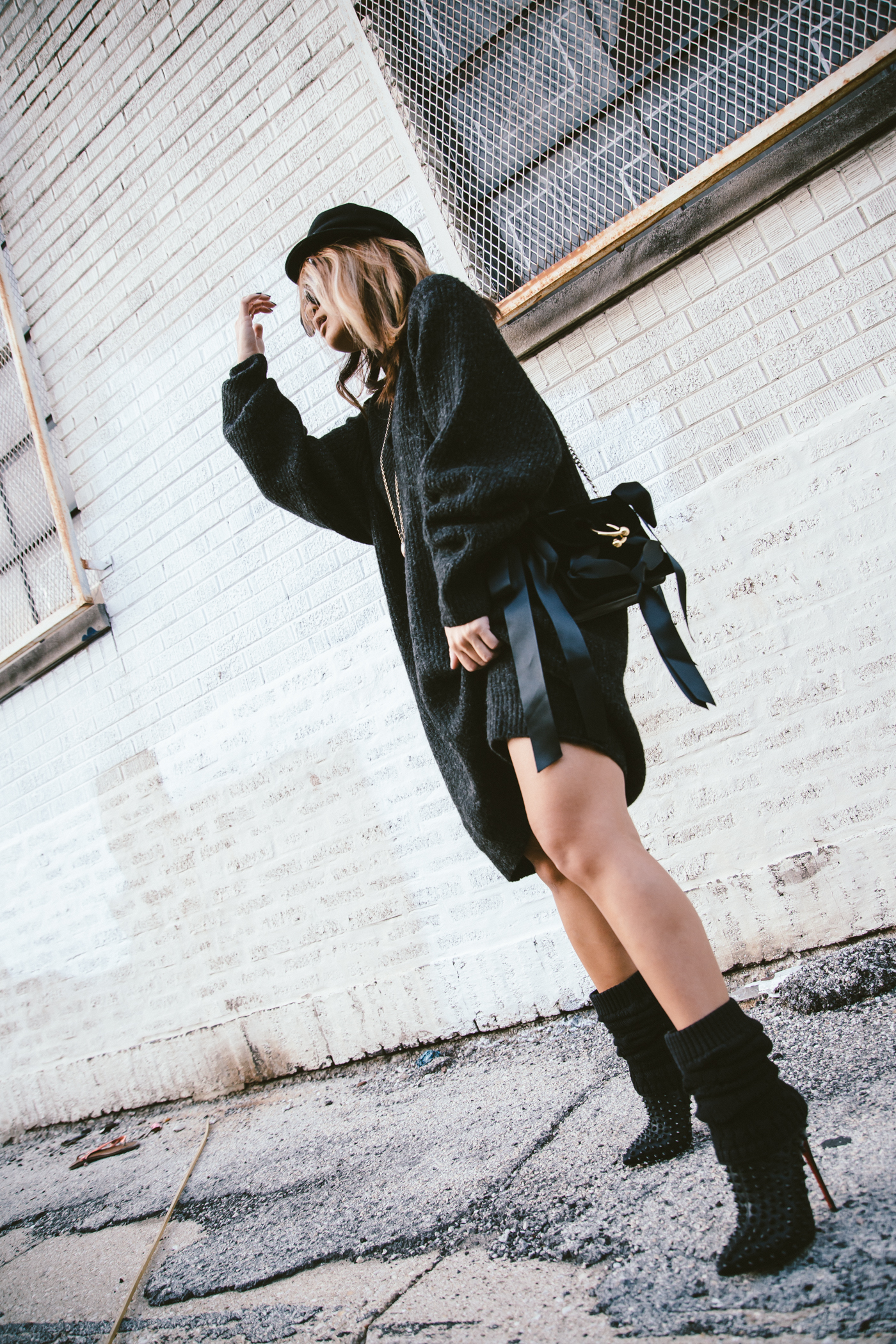 oversized sweater dress with christian louboutin ankle boots and leg warmers newsboy cap and jw anderson bow pierce bag