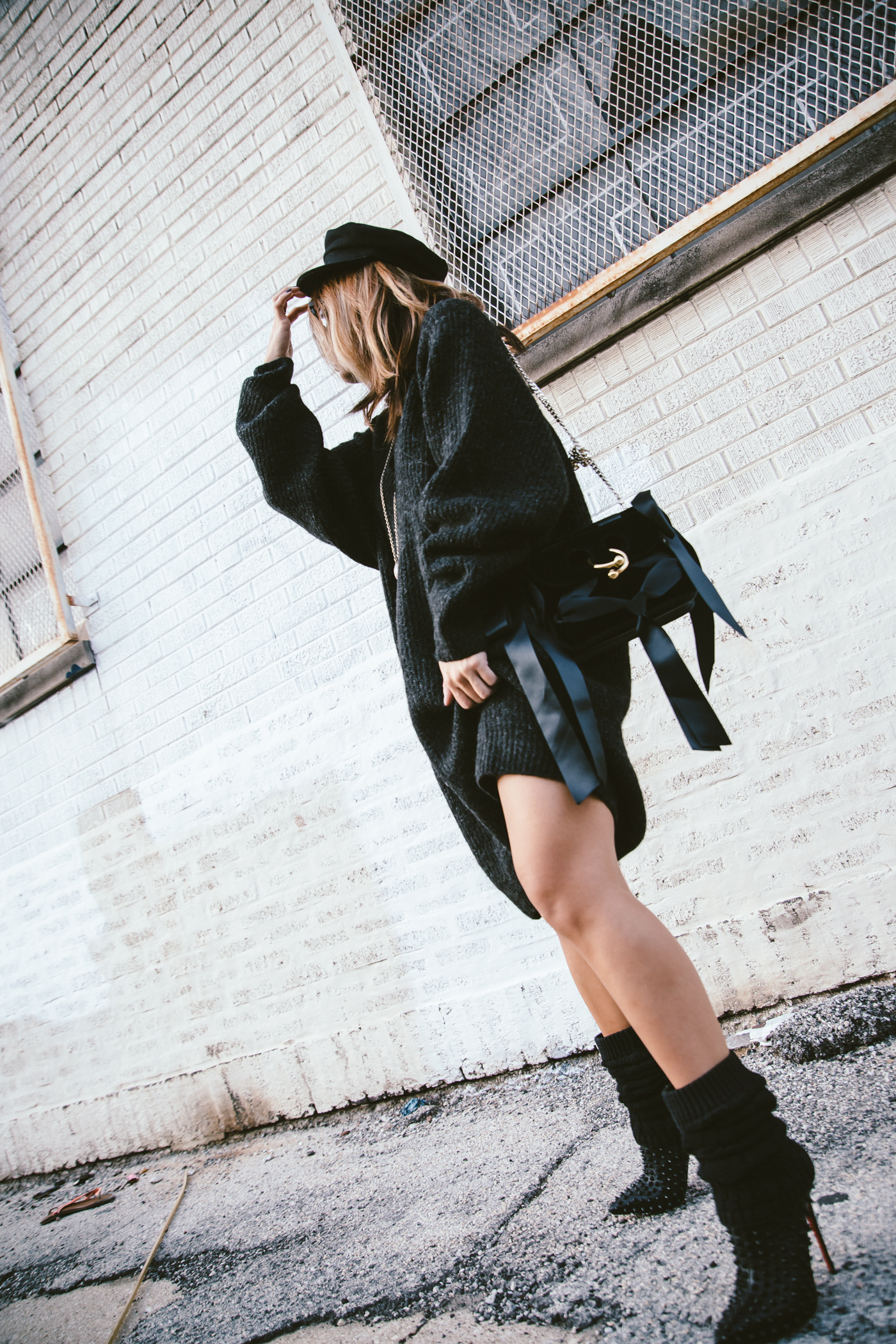 oversized sweater dress with christian louboutin ankle boots and leg warmers newsboy cap and jw anderson bow pierce bag