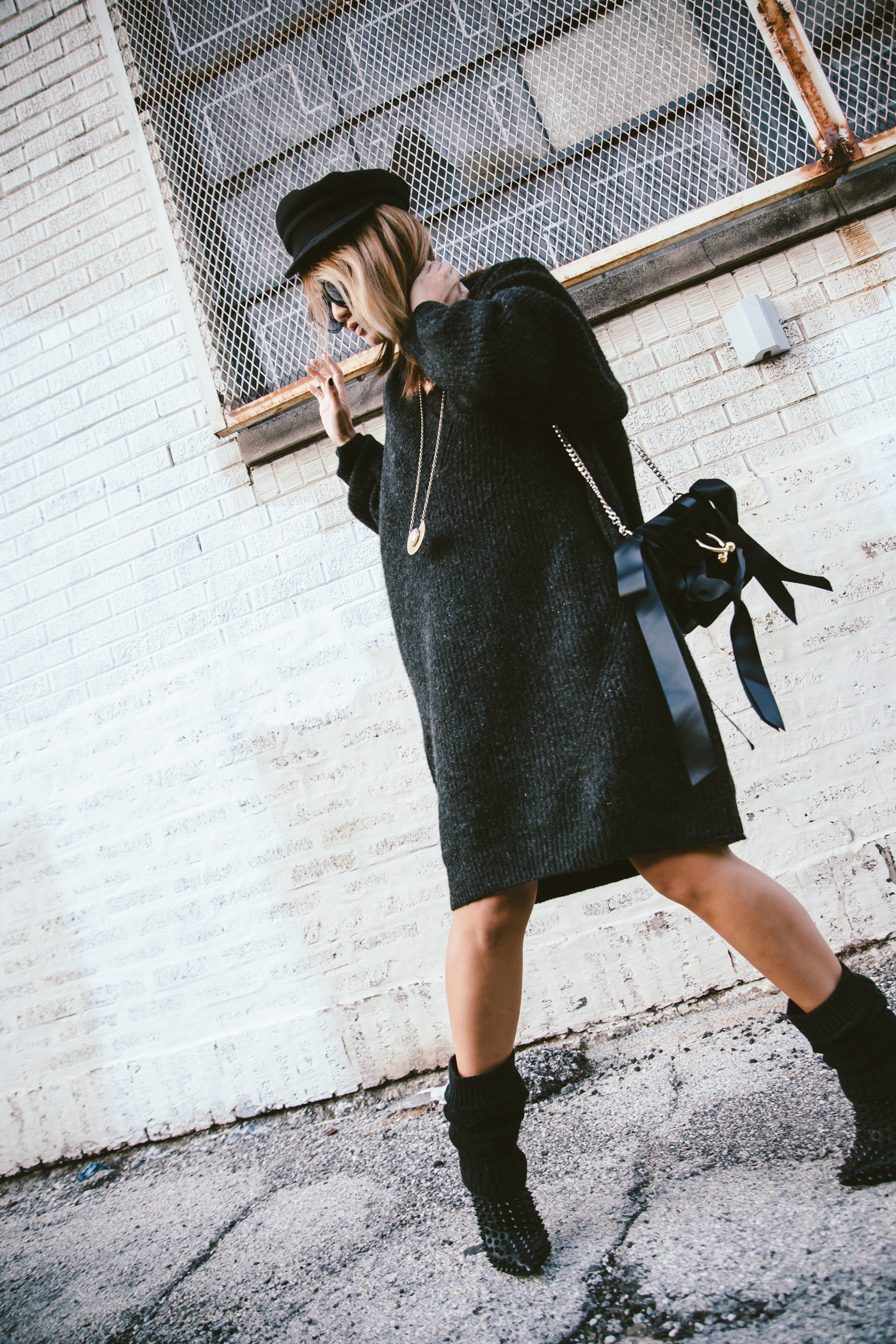 oversized sweater dress with christian louboutin ankle boots and leg warmers newsboy cap and jw anderson bow pierce bag