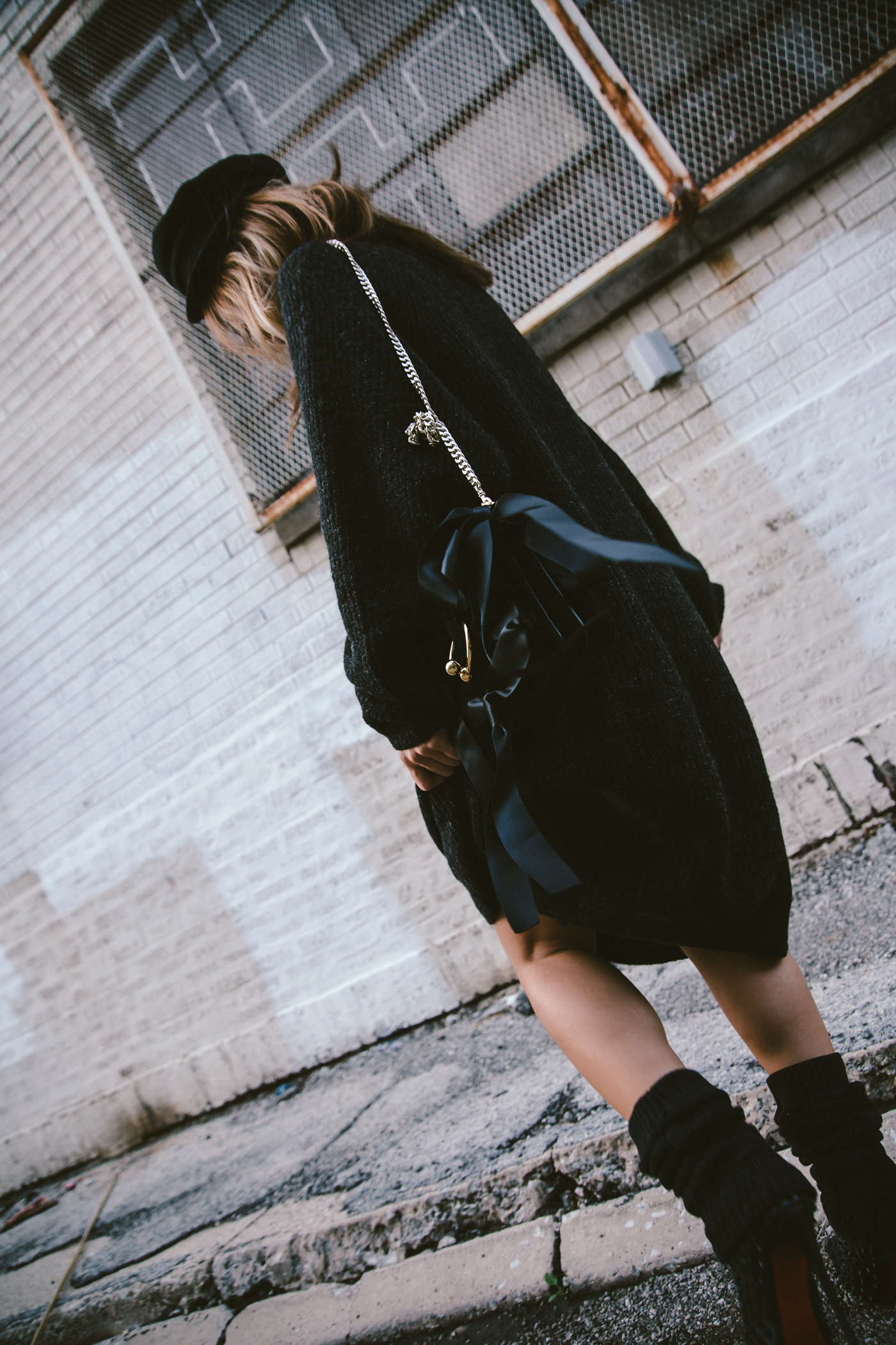 oversized sweater dress with christian louboutin ankle boots and leg warmers newsboy cap and jw anderson bow pierce bag